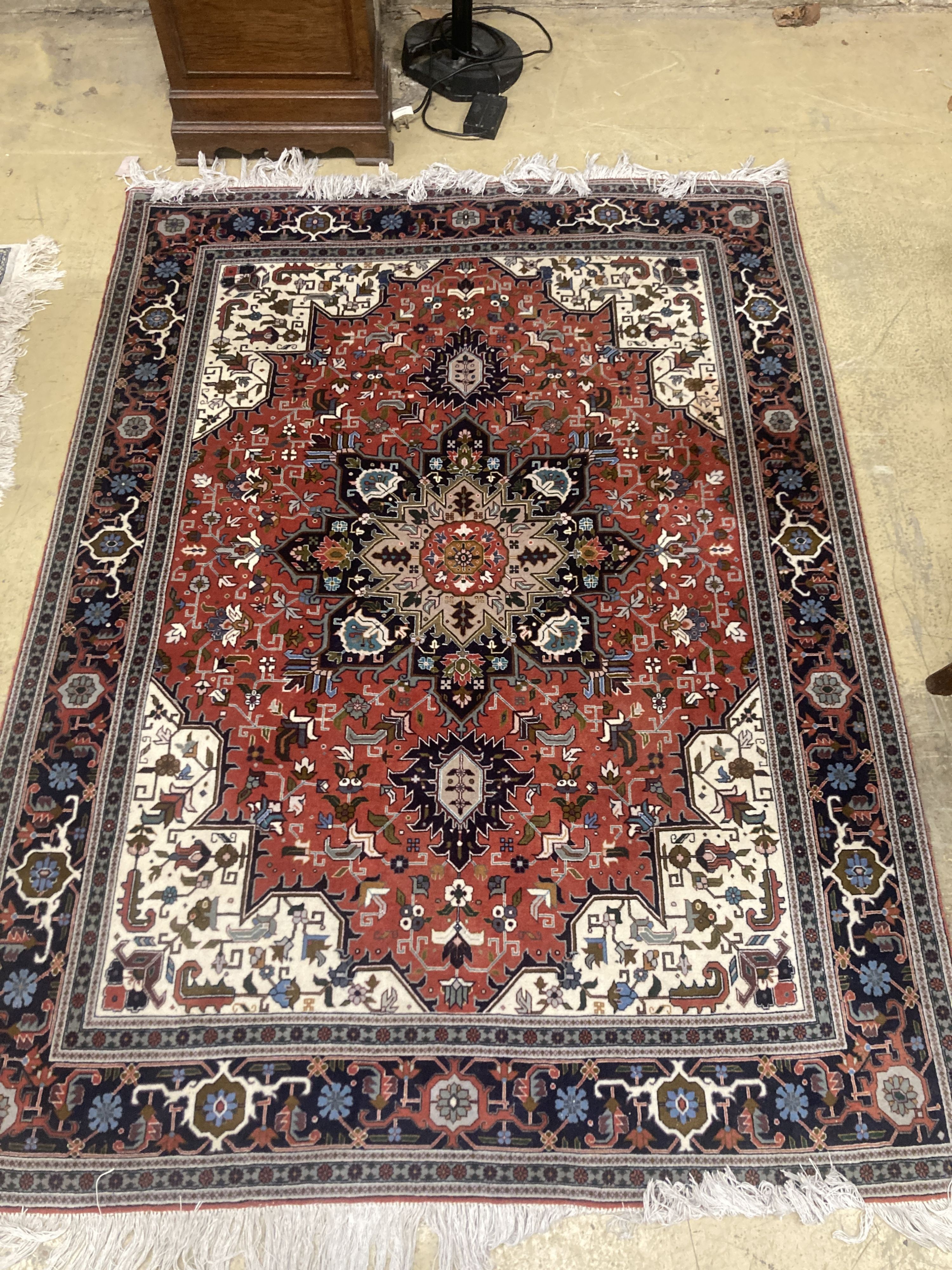 A Heriz style brick red ground rug, 206 x 150cm